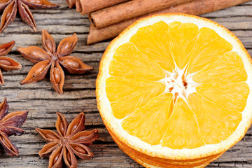Sliced od dried orange with cinnamon sticks and star anise