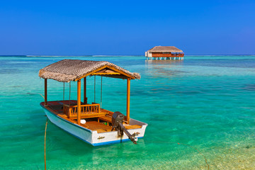 Boat and bungalow on Maldives island
