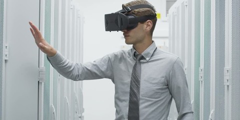 Man using virtual reality headset against server room with towers. Shot on RED Helium 8K - Powered by Adobe