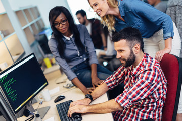 Software engineers working on project and programming in company