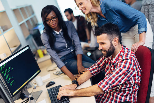 Software engineers working on project and programming in company