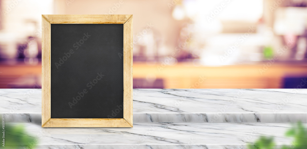 Poster blank blackboard on step white marble table top with blur restaurant kitchen background bokeh light 