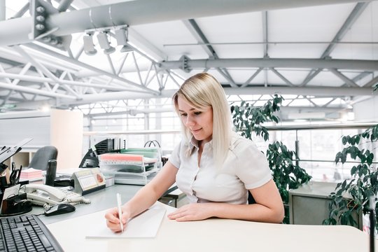 beautiful girl sitting at Desk with documents