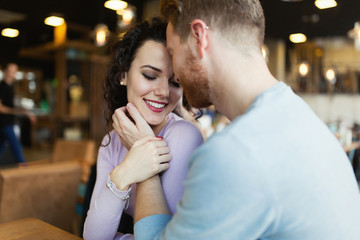 Fototapeta premium Young happy couple on date in coffee shop