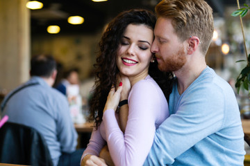 Fototapeta premium Young happy couple on date in coffee shop