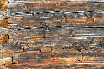 Old natural brown wood wall of log cabin. Wooden textured background pattern.
