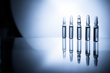 Medical ampules for injection isolated on blue background