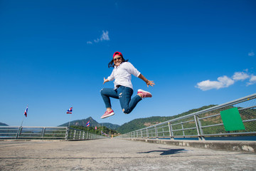happy woman jump with blue sky.