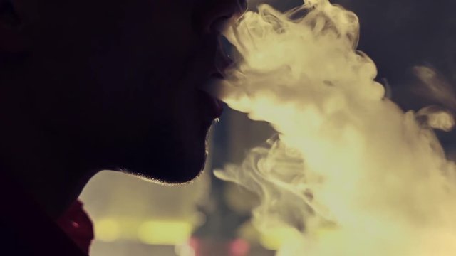 Young man smoking hookah in a bar