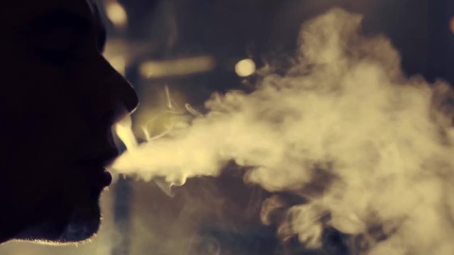 Young man smoking hookah in a bar