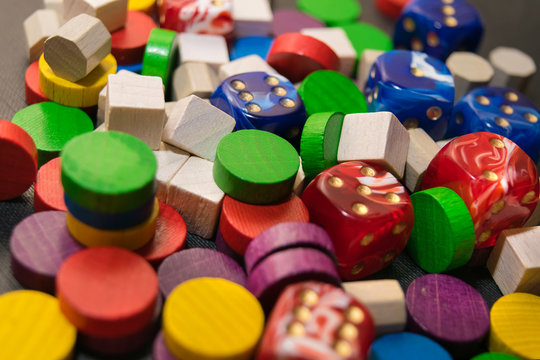 a multicolored pile consisting of dice and wooden chips
