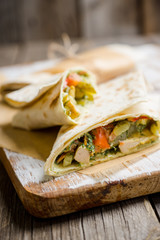 Shawarma with sauce on the rustic wooden background. Selective focus. Shallow depth of field.