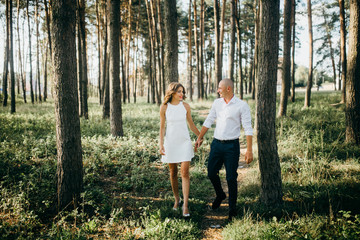 Naklejka na ściany i meble Amazing young couple in the forest
