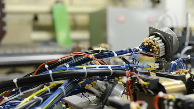 Harnesses of electrical cables lie on the circuit board.