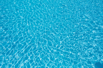 Blue and bright ripple water and surface in swimming pool , Beautiful motion gentle wave in pool