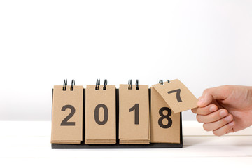 New Year 2018 is coming concept. Hand change 2017 to 2018 .