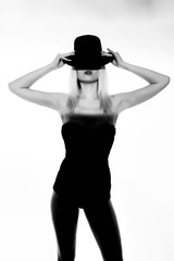 Fototapeta premium Beautiful blonde girl in black body and heels with visible shadow