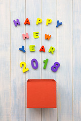 New Year 2018 is coming concept. Colorful wooden word happy new year 2018 stream out of gift box on...