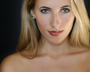 Fototapeta premium Portrait of beautiful sensual woman with green eyes. Studio shot.