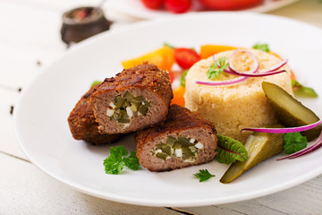Zrazy cutlets with minced meat with pickled cucumber and eggs and garnish of bulgur