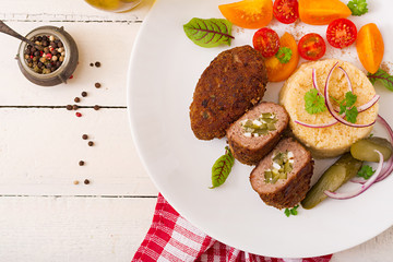 Zrazy cutlets with minced meat with pickled cucumber and eggs and garnish of bulgur