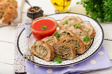 Roll of chicken minced meat with broccoli and tomato sauce.