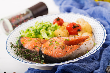 Dietary menu. Baked salmon steak with cauliflower, tomatoes and herbs. Proper nutrition. Healthy lifestyle