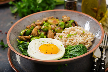 Healthy breakfast. Oat porridge, egg and salad of baked vegetables - mushrooms and Brussels sprouts. Healthy lifestyle.