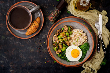 Healthy breakfast. Oat porridge, egg and salad of baked vegetables - mushrooms and Brussels sprouts. Healthy lifestyle. Top view