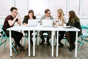 Startup business ideas sitting at a Desk creative group of businessmen solved the economic objectives of the firm