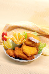 Breaded Fried fish with potato fries and tomato ketchup with lemon cherry tomato