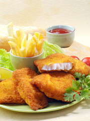 Breaded Fried fish with potato fries and tomato ketchup with lemon cherry tomato