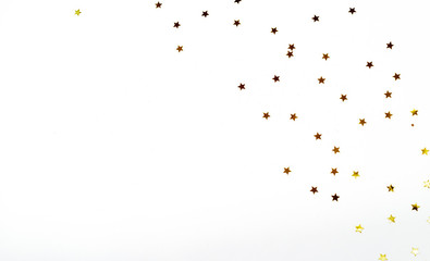 Fototapeta premium Christmas composition. a pattern of golden christmas stars from above. Flat lay, top view