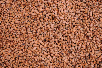 Heat expanded clay pebbles used as a growing media in hydroponics. Background close up of pellets.