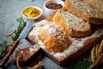 Bread and pastries in a composition with kitchen accessories on an old background