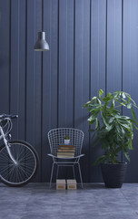 Fototapeta na wymiar decorative home design metal chair vase of flowers and lamp style dark blue wall