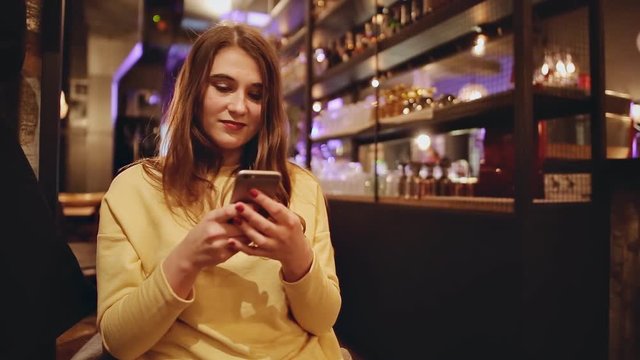 Young caucasian woman at restaurant using smart phone