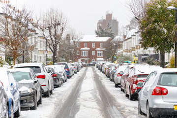 Terraced street covered with snow around West Hampstead area in London