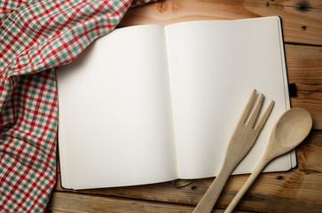 Blank recipe book on wooden table.