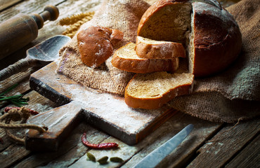 Bread and pastries in a composition with kitchen accessories on an old background