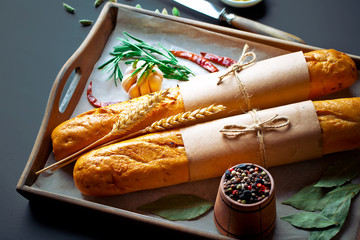 Bread and pastries in a composition with kitchen accessories on an old background