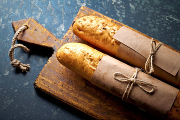 Bread and pastries in a composition with kitchen accessories on an old background