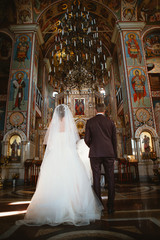 newlyweds wedding ceremony in the church,wedding ceremony, glans