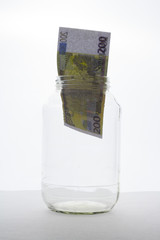 bank note in jar on white background