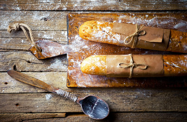 Bread and pastries in a composition with kitchen accessories on an old background