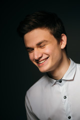 young brunette guy in a white shirt