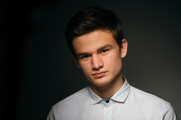 young brunette guy in a white shirt