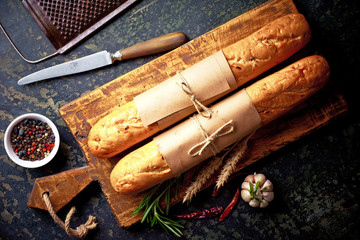 Bread and pastries in a composition with kitchen accessories on an old background
