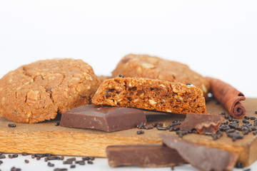 Chocolate chip cookies on wooden board and white background. Sweet biscuits. Homemade pastry