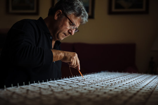 Man weaving a tapestry